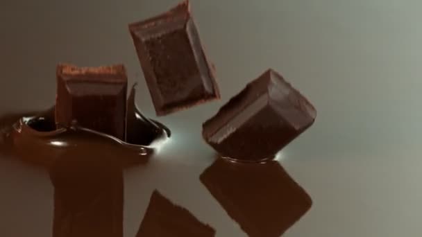 Super Slow Motion Falling Chocolate Pieces Melted Chocolate Filmed High — Vídeo de Stock