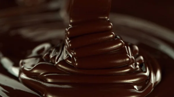 Close Pouring Stream Melted Chocolate Creating Curly Shapes — Stockfoto
