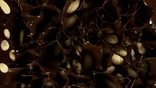 Super Slow Motion Falling Blanched Almonds Melted Chocolate Filmed High — Video