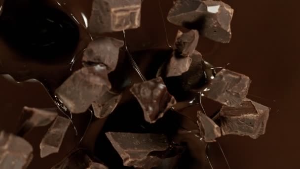 Super Slow Motion Falling Chocolate Pieces Melted Chocolate Filmed High — Vídeo de Stock