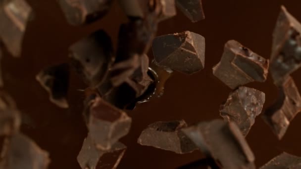 Super Slow Motion Falling Chocolate Pieces Melted Chocolate Filmed High — Stok video