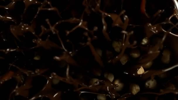 Super Slow Motion Falling Blanched Hazelnuts Melted Chocolate Filmed High — Wideo stockowe