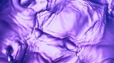 Super slow motion of splashing colored water waves. Filmed on high speed cinema camera, 1000 fps.