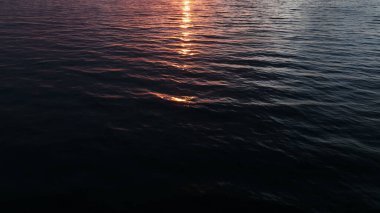 Sunset over the ocean. Ocean wave closeup.