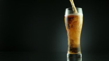 Super slow motion of overflowing foam from glass, placed on black background. Filmed on high speed cinema camera, 1000 fps. Speed ramp effect.