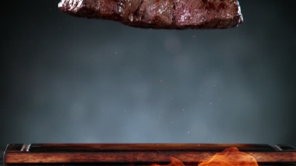 Flying Pieces Grilled Beef Steak Fire Falling Table Filmed High — Stock videók