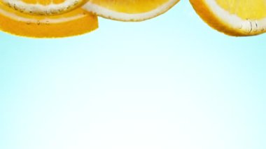 Super slow motion of falling orange slices into water. Filmed on high speed cinema camera, 1000 fps.