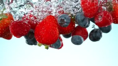 Super slow motion of falling berries underwater. Filmed on high speed cinema camera Phantom VEO 4K, 1000 fps.
