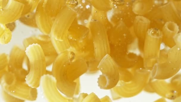 Super Slow Motion Flying Italian Pasta Pipe Rigate Water Filmed — Stock video