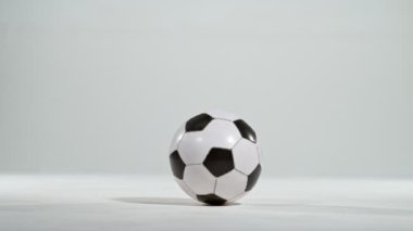 Super slow motion of jumping soccer ball on white background. Filmed on high speed cinema camera, 1000fps. Speed ramp effect.