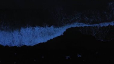 Aerial panoramic footage of Icelandic Diamond Beach. Top view above black volcanic beach with icebergs, shot in evening.