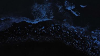 Aerial panoramic footage of Icelandic Diamond Beach. Top view above black volcanic beach with icebergs, shot in evening.