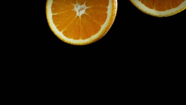 Super Slow Motion Falling Orange Pieces Isolated Black Background Filmed — Stockvideo