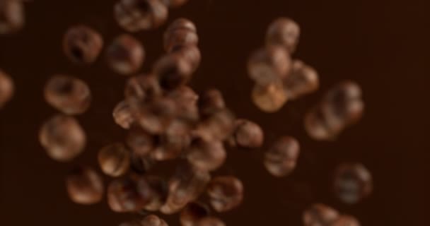 Super Slow Motion Falling Hazelnuts Melted Chocolate Filmed High Speed — Stock videók