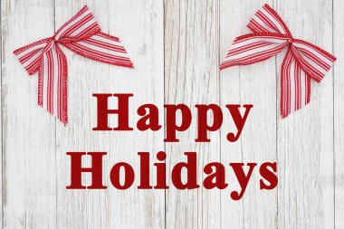 Mutlu tatiller, kırmızı ve beyaz baston şekerlerle yıpranmış ahşap üzerinde selamlar.