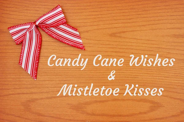 キャンディ杖願いとミステリーキスGreetingとともにクリスマス赤と白のキャンディー杖弓上の木 — ストック写真