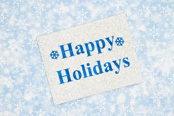 幸せな休日の挨拶銀の輝きグリーティングカード上の青と白の雪の結晶 — ストック写真