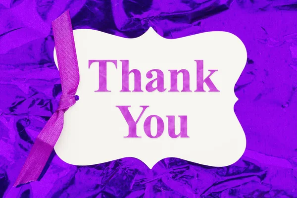 Thank you gift tag over colorful purple glossy paper for your fun or party message