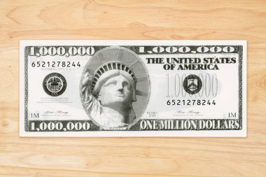 Inflation in the USA with a fake million dollar bill on a wood desk