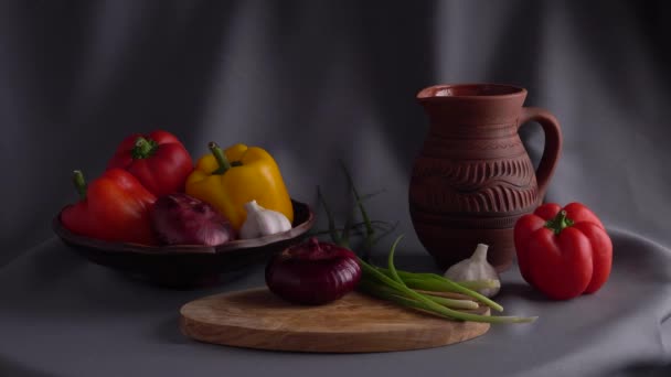 Still life with vegetables on a gray drapery background. — Stock Video