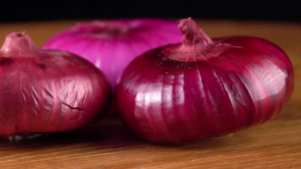 Red onion on black background — Stock Video