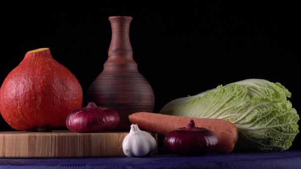 Still life with vegetables on a black background. — Stock Video