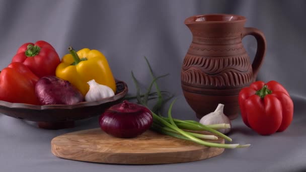 Still life with vegetables on a gray drapery background. — Stock Video