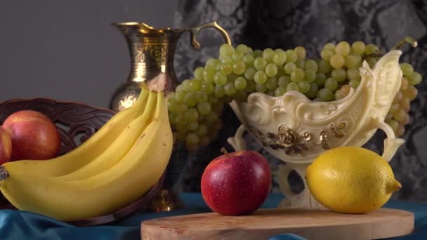 Stilleven met fruit. Groene druiven, appelen, bananen en citroen — Stockvideo