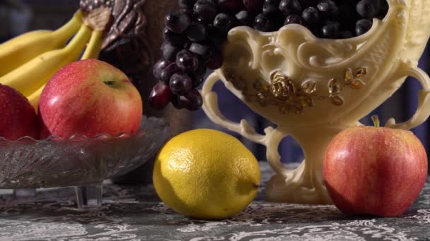 Meyvelerle dolu bir hayat. Siyah üzüm, elma, muz ve limon — Stok video