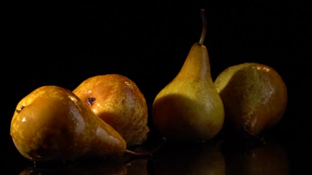 Yellow pears with water drops on black background — Stock Video