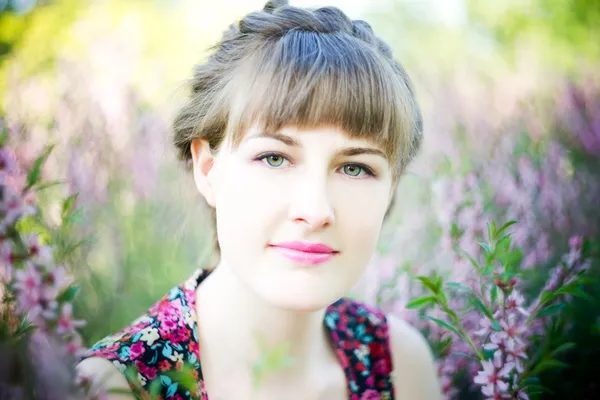 Beautiful young woman with flowers — Stock Photo, Image