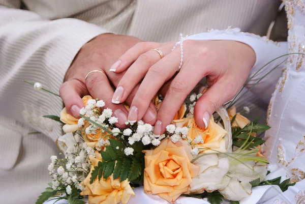 Bouquet and hands with rings Stock Picture