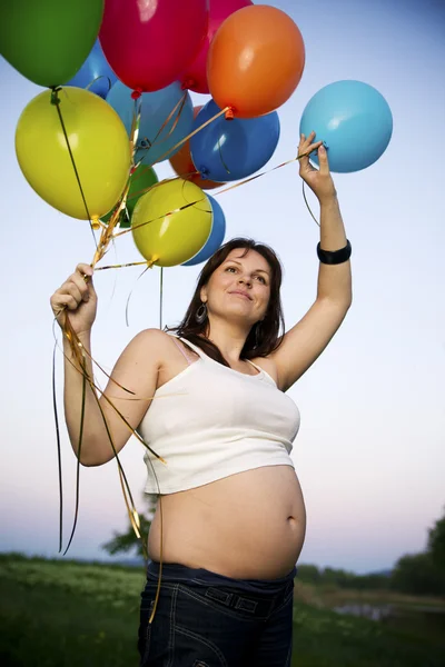 Pregnant woman in nature Stock Picture
