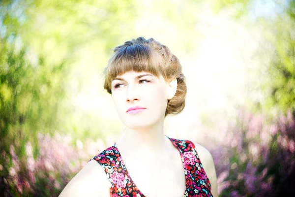 Beautiful young woman with flowers — Stock Photo, Image