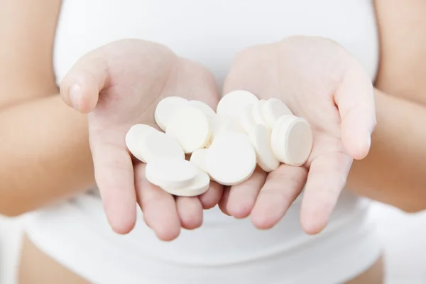 Pastillas en las manos de las mujeres — Foto de Stock