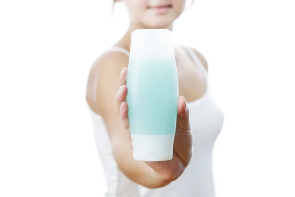 Bottle with cream in a female hand — Stock Photo, Image