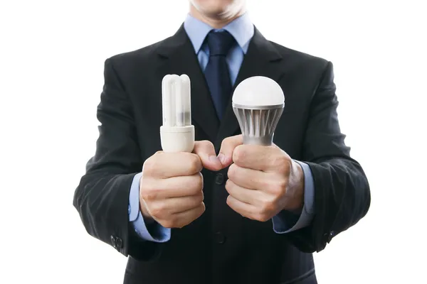 Businessman with fluorescent and LED lamps and incandescent — Stock Photo, Image