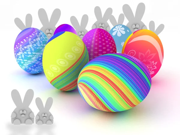 Coelhos de Páscoa e ovos coloridos isolados em fundo branco — Fotografia de Stock