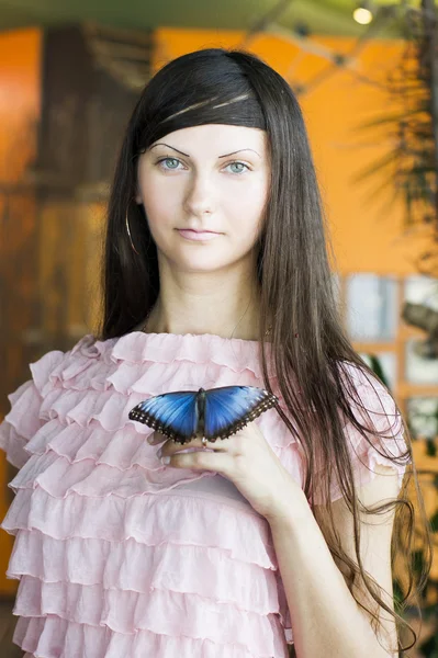 Portrait of beautiful girl with butterfly in a greenhouse — Stock Photo, Image