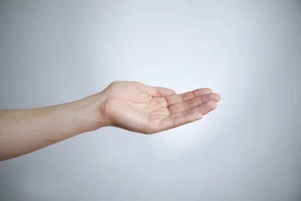 Männliche Hand auf grauem Hintergrund — Stockfoto