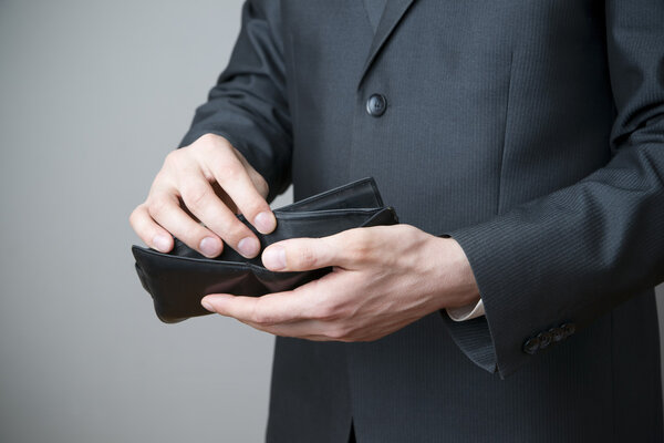 Businessman with empty purse in hands