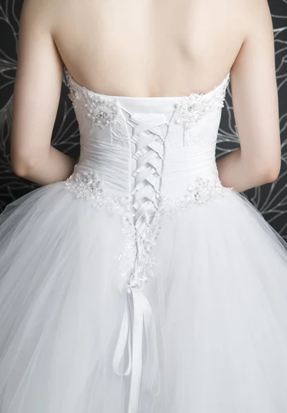 Woman's back in white wedding dress with corset — Stock Photo, Image