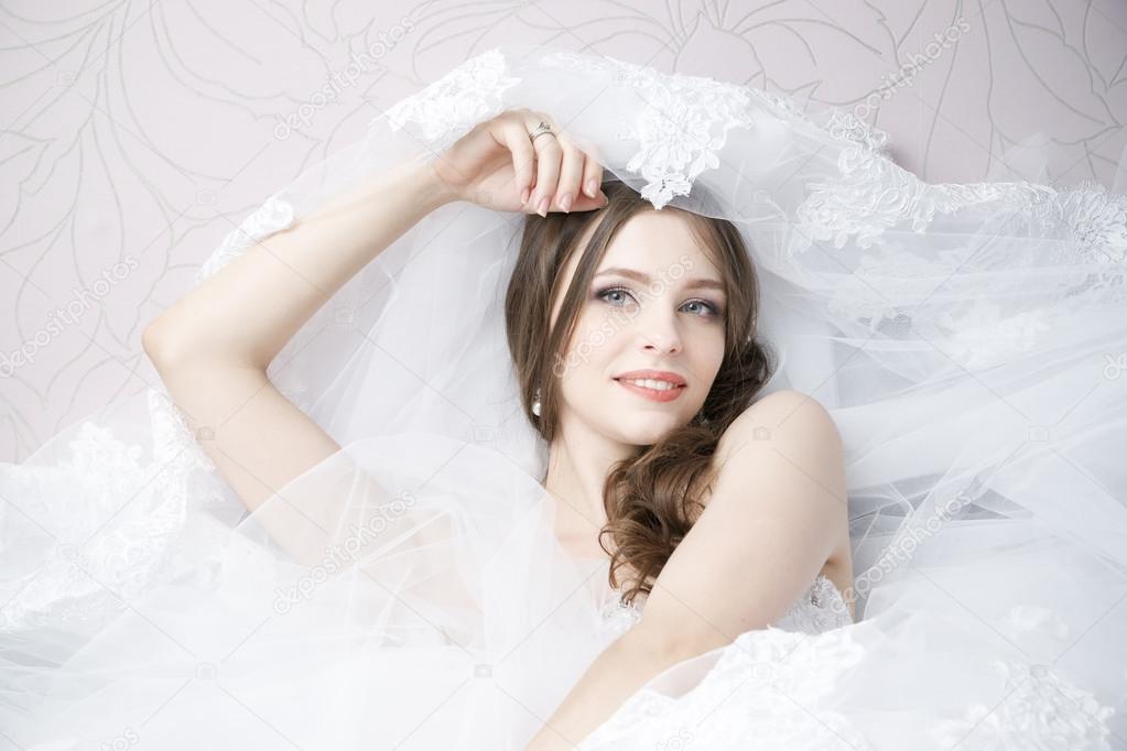 Portrait of a happy bride in white wedding dress