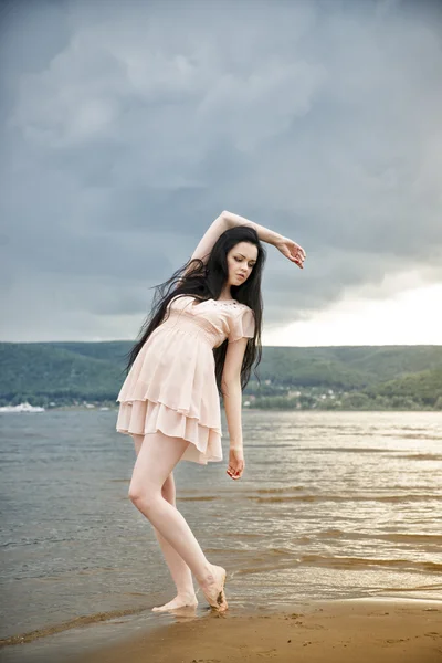 Mooie jonge vrouw op een zandstrand — Stockfoto