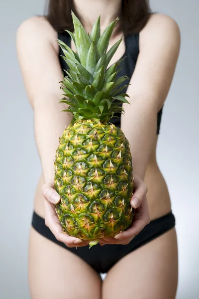 Overweight of the women with pineapple — Stock Photo, Image