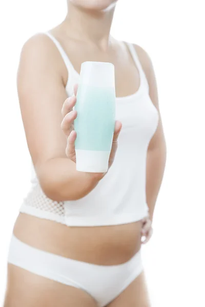 Bottle with cream in a female hand — Stock Photo, Image