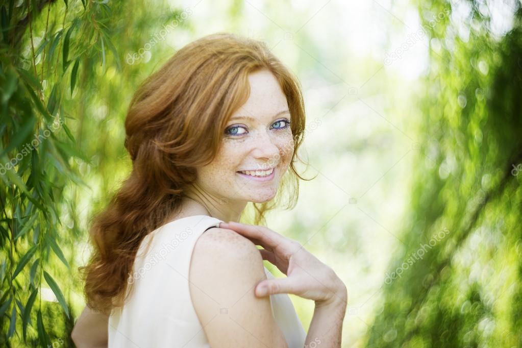 Portrait of redhead girl on nature
