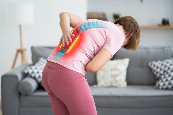 Lumbar intervertebral spine hernia, woman with back pain at home, spinal disc disease, health problems concept