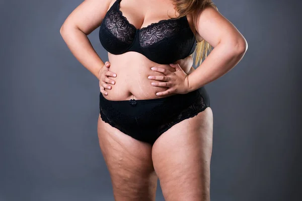 Plus size model in black lingerie, overweight female body, fat woman with  flabby stomach isolated on white background Stock Photo by ©starast  138180764