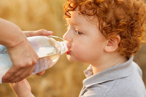 Baby boy drinking water — Stock Photo, Image